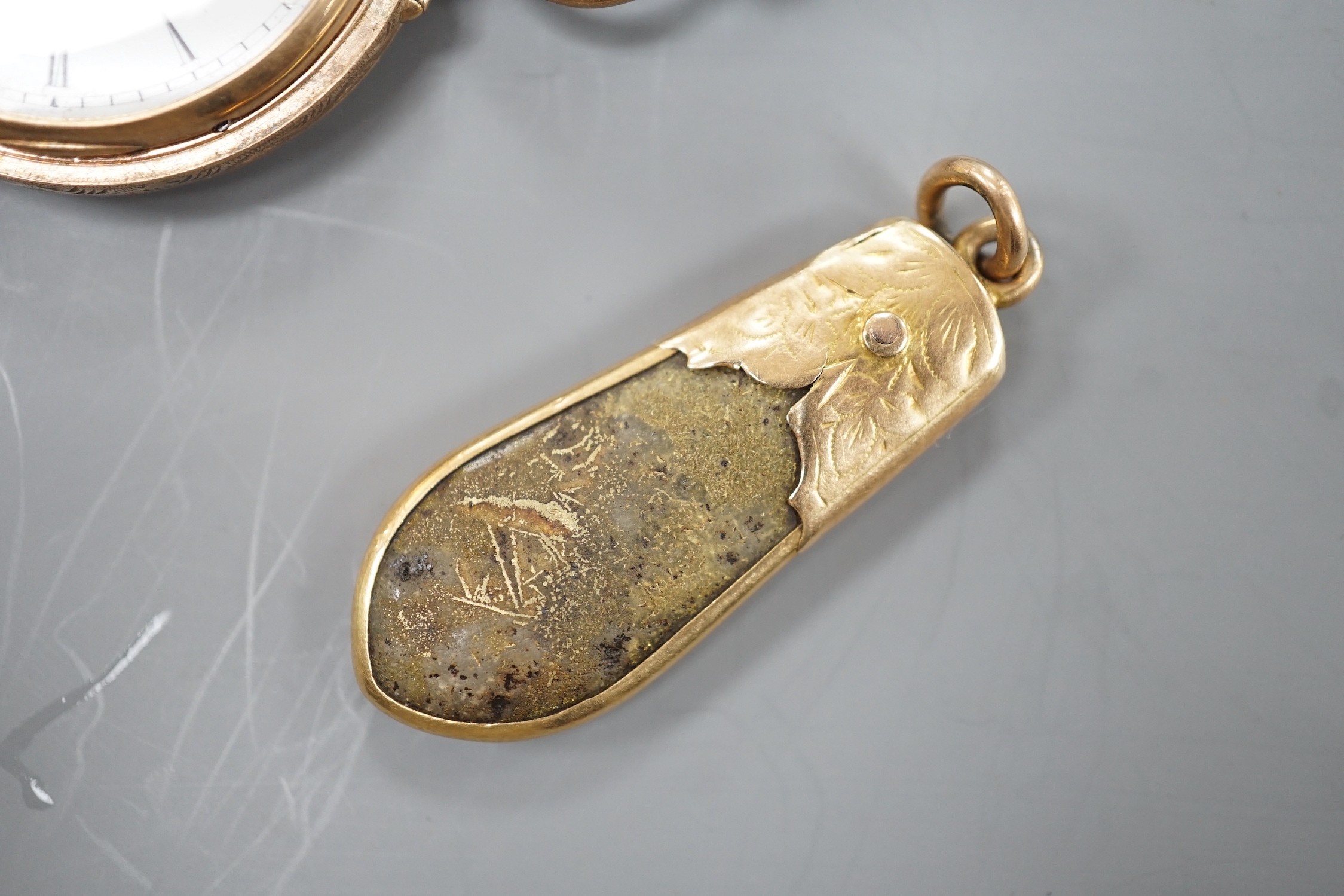 An early 20th century engraved 9ct gold hunter fob watch, with Roman dial, gross 36.7 grams, on a blue sash with yellow metal mounted hardstone fob.